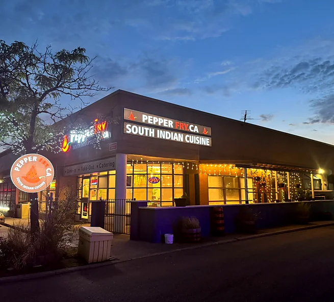 pepperfryca.ca restaurant building on Matheson Blvd E at dusk, with warm lights in the windows