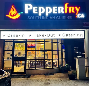 pepperfryca.ca South Indian Cuisine storefront at night, with the lit sign and Dine-in, Take-Out and Catering banner